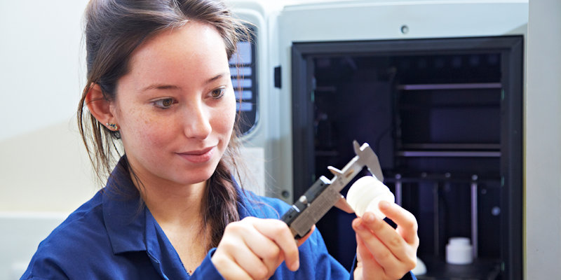 Female Product Design student measuring a part