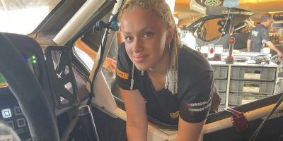 Lily Owuye leaning into a car.
