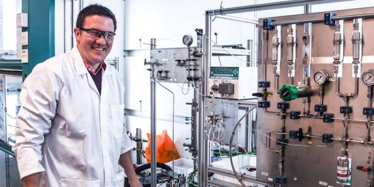 Professor Richard Bourne wearing a white lab coat and safety glasses in a lab.