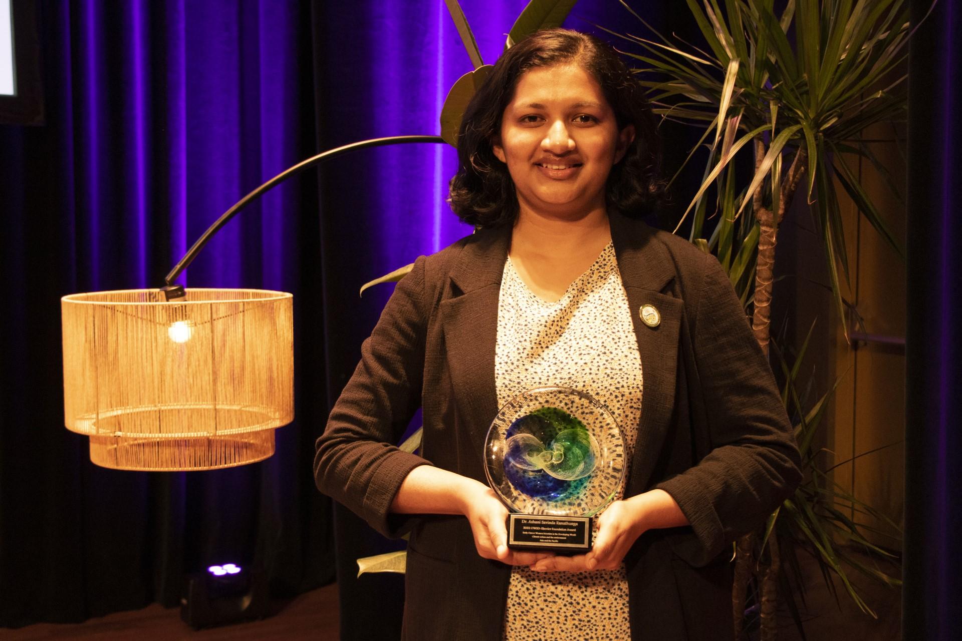 Dr Ashani Ranathunga holding her 2022 OWSD-Elsevier Foundation Award.