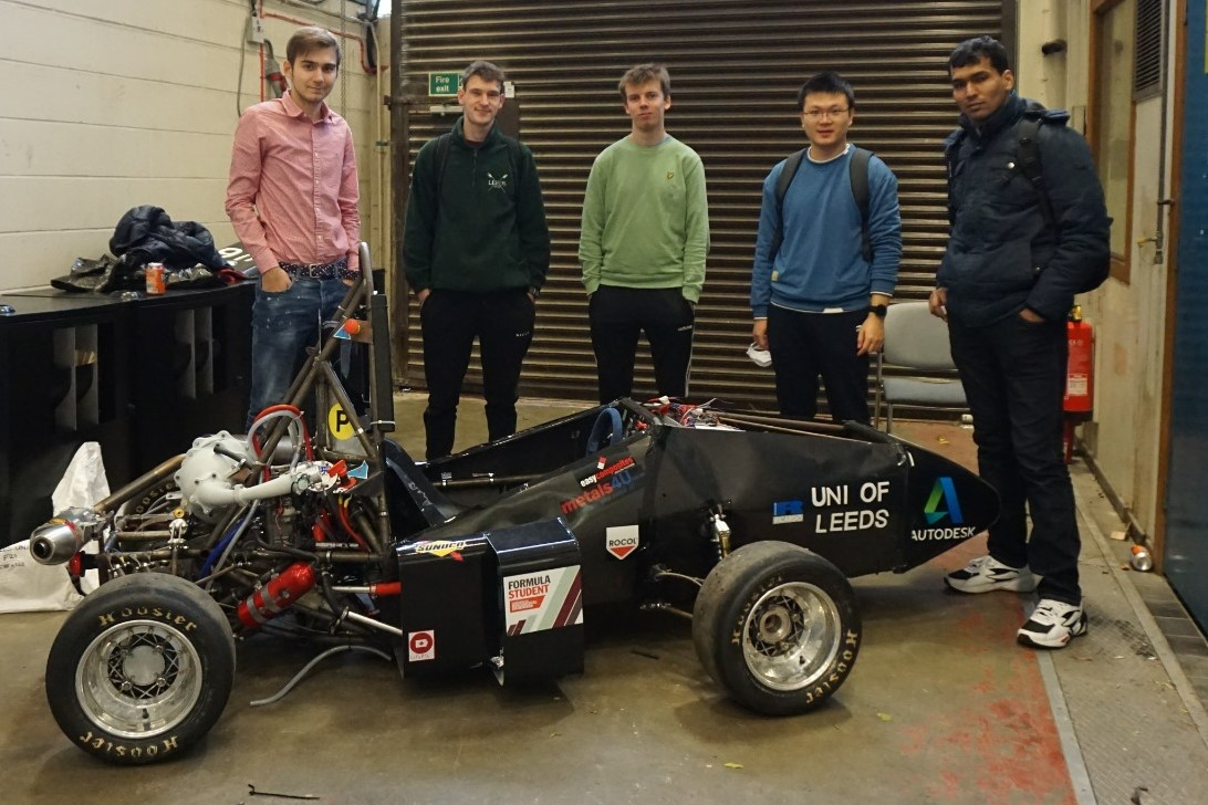 Group of male students with a car they built at Formula Student Society