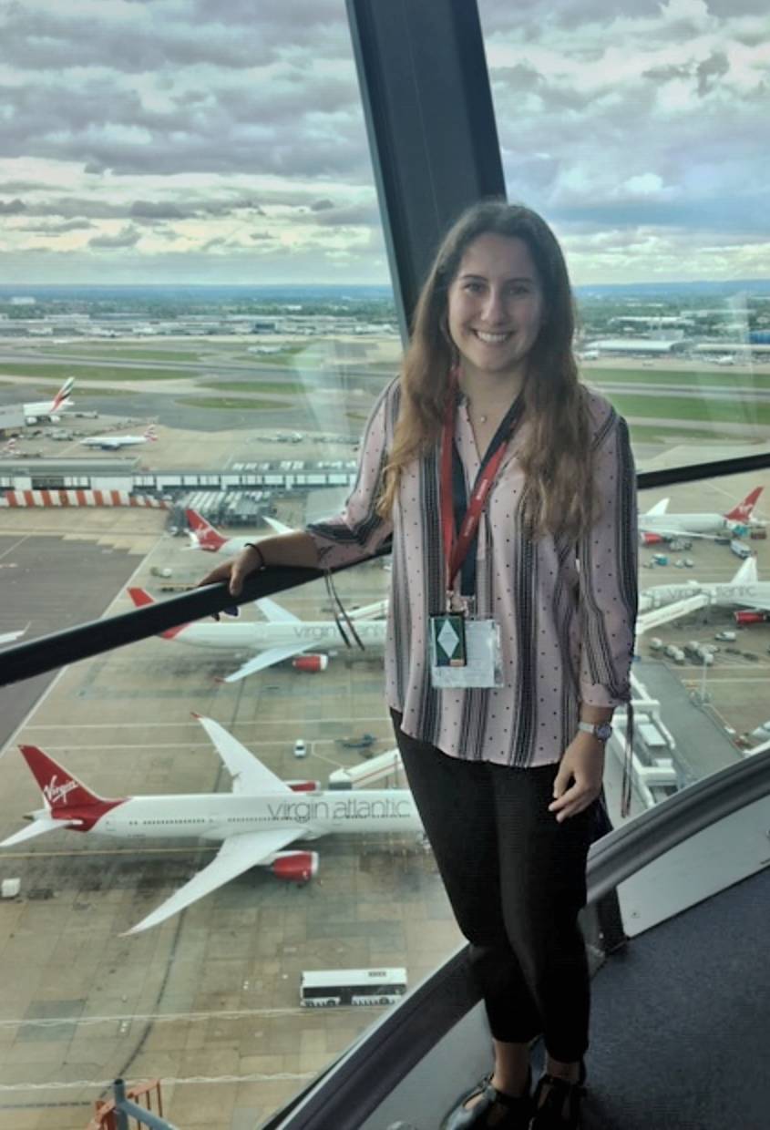 Holly Dimmick standing in front of a number of airplanes