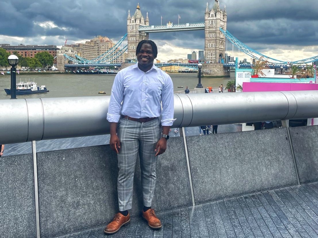 Jonathan standing in front of London Bridge and the river thames on his last day of his year in industry