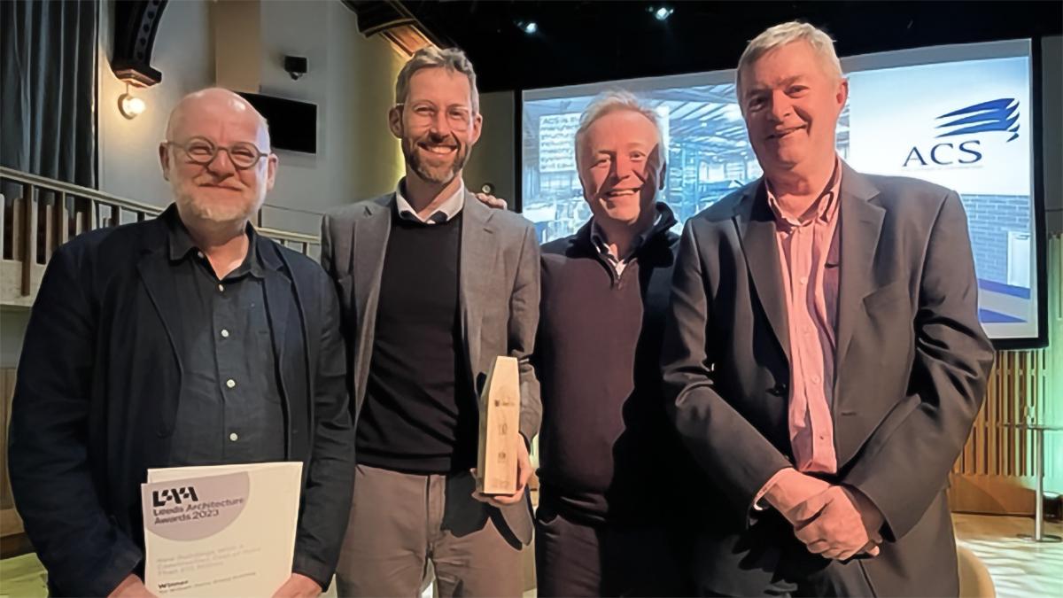 Winners at the Leeds Architecture Awards, holding the award, including Jon Roylance (ADP), Joe Morgan (ADP), David Oldroyd and Jerry Lee.