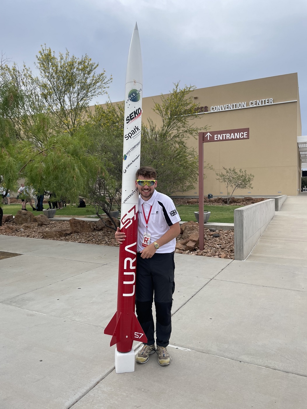 A photograph of Jake Hollyman stood with the Gryphon 1 rocket.