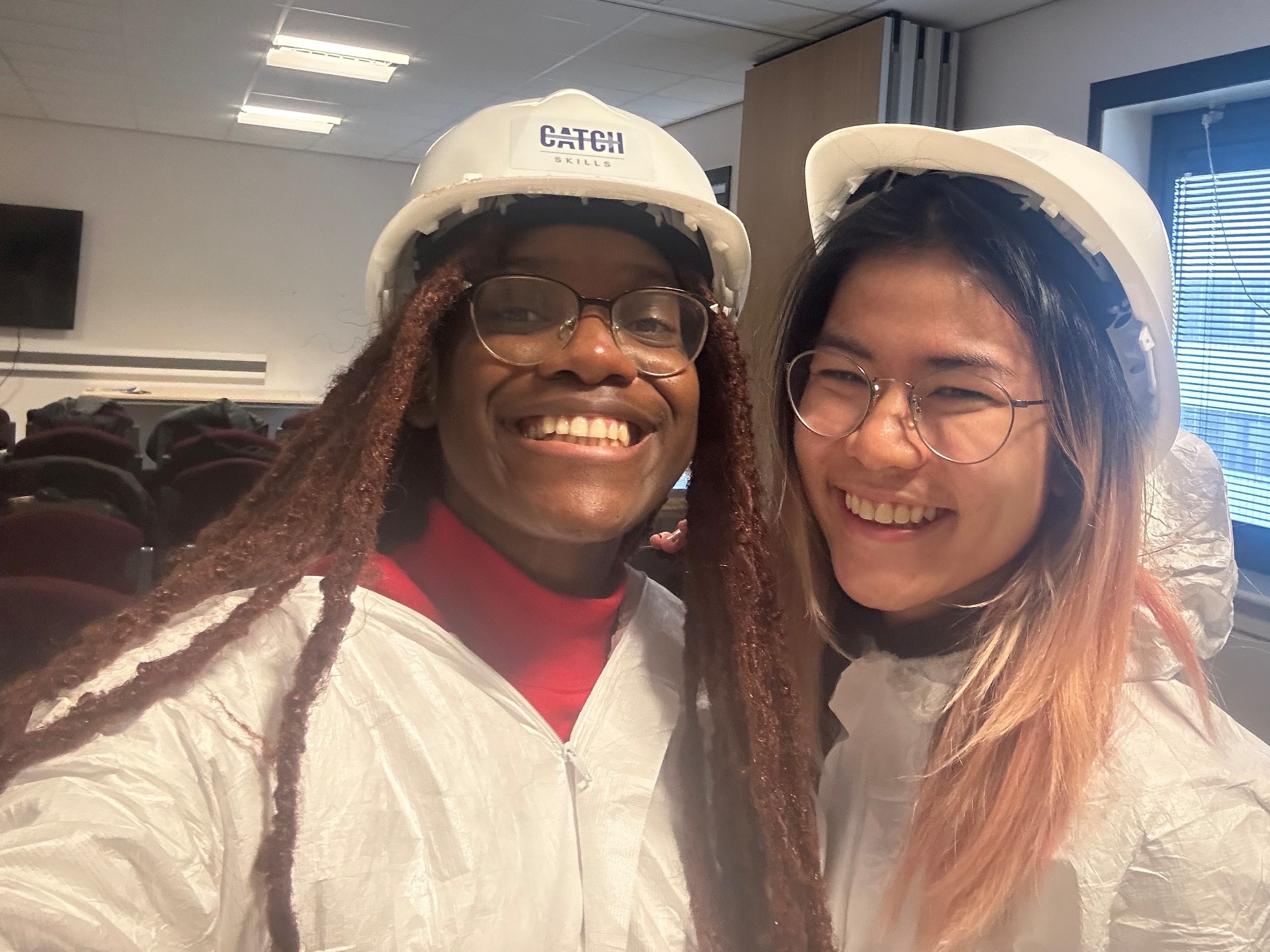 Rafaela with a friend on the field trip wearing safety clothing