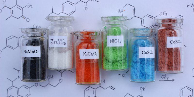 Chemically purified salts for analytical chemistry: black sodium permanganate, white zinc sulfate, orange potassium dichromate, green nickel chloride, blue copper sulfate, brown cobalt sulfate.