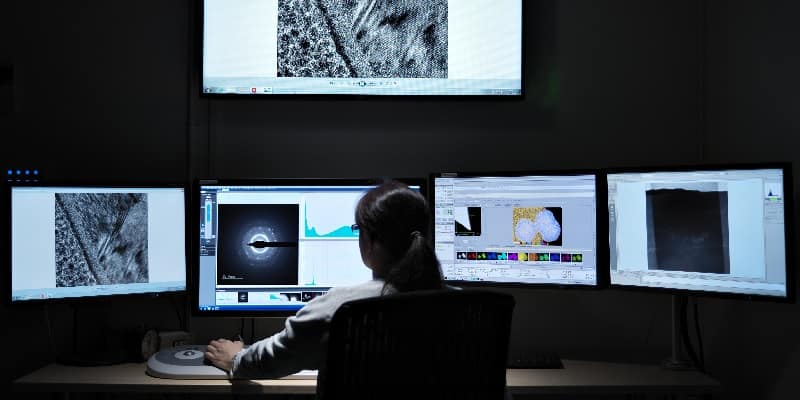 person viewing electron microscope images of materials