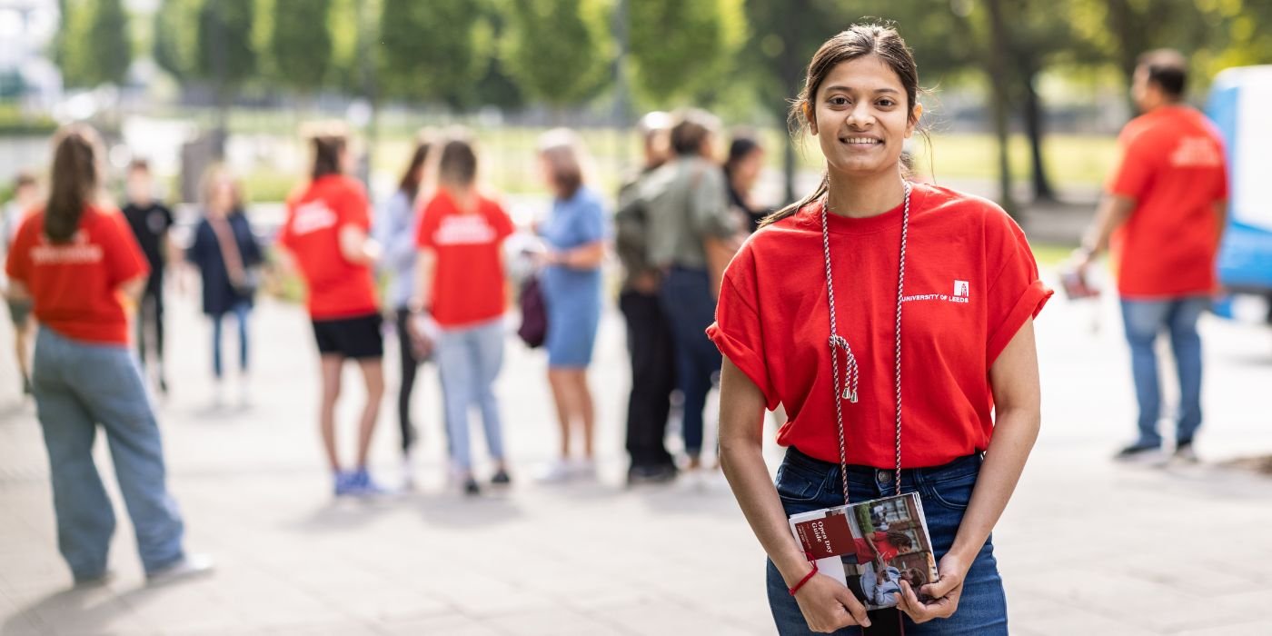 利兹大学开放日校园内穿着红色大使t恤的学生照片。