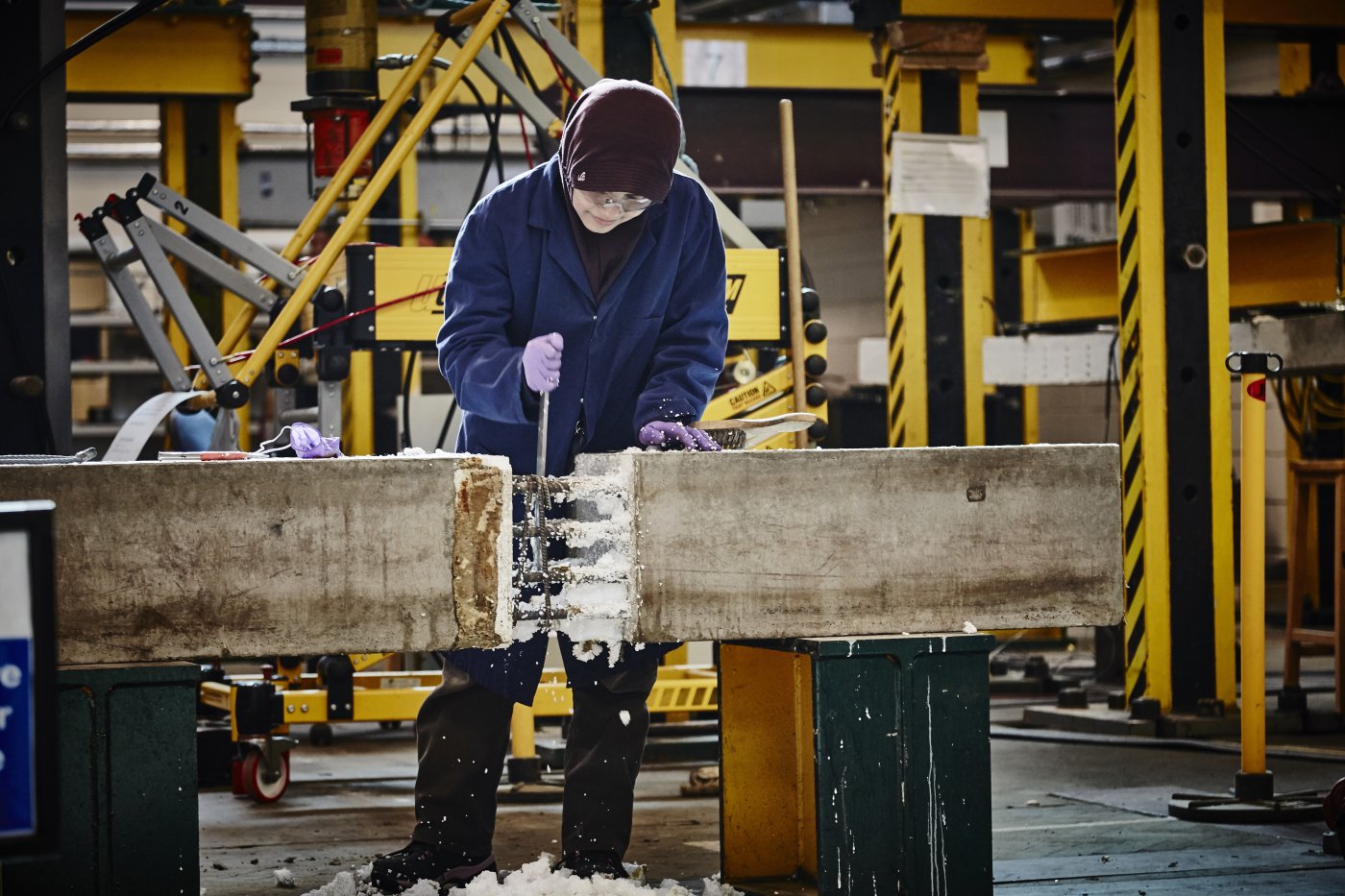 Image of an undergraduate Civil Engineering student at the University of Leeds carrying out an activity on a concrete structure in a lab session.