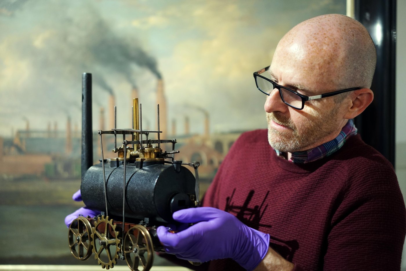 John McGoldrick, of Leeds Museums and Galleries, holding Matthew Murray's model steam locomotive.