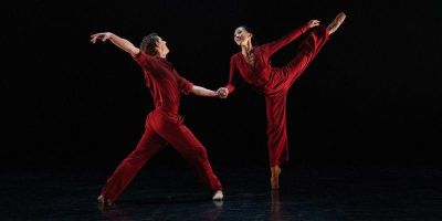 Dancers Minju Kang and Jonathan Hanks wearing red outfits while dancing in a performance Nostalgia
