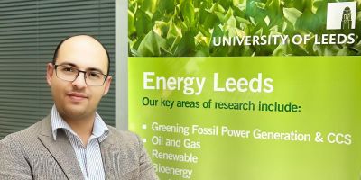 Dr Ahmed Gailani stood next to a poster that read Energy Leeds.