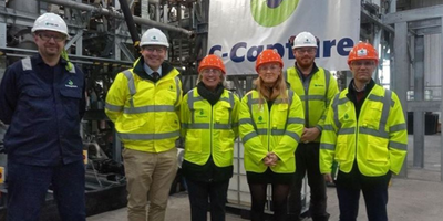 Six people in hi-vis jackets and helmets standing in front of a C-Capture logo
