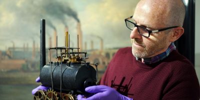 John McGoldrick, of Leeds Museums and Galleries, holding Matthew Murray's model steam locomotive.