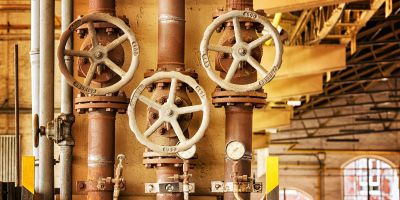 A photograph of old pipes in a building.