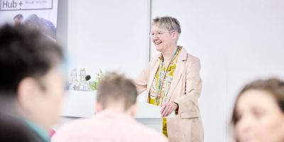 Louise Jennings speaking at a lectern.