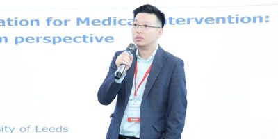 Picture of a man wearing a suit holding a microphone