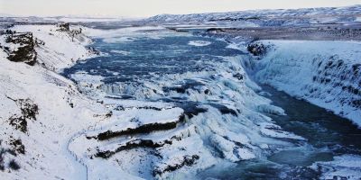 Waterfall in Iceland surrounded by ice and snow