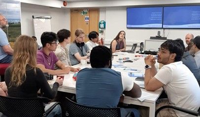 A group of students sat at a table listening to a presentation by staff members of Arquiva’s Emley Moor Transmitting Facility.