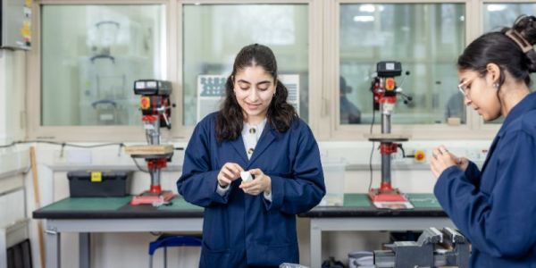 A photograph of Ruqaiya Al Balushi in the Prototyping Workshop in the School of Mechanical Engineering.