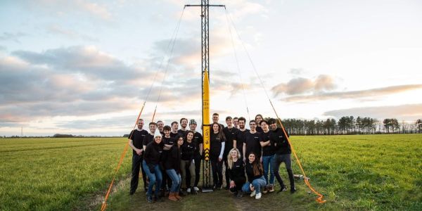 A group shot of Leeds University Rocket Association (LURA) stood with their rocket in the middle.