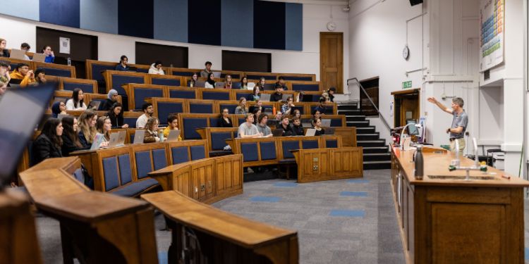 Students in a lecture theatre listening to an academic