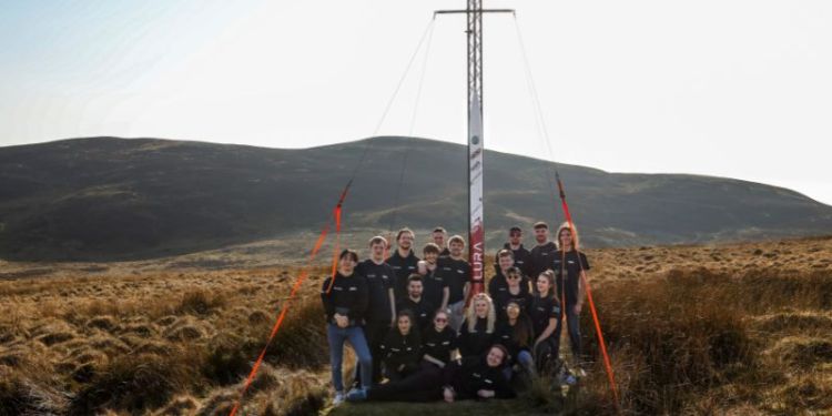 A group photograph of the LURA team with their rocket.