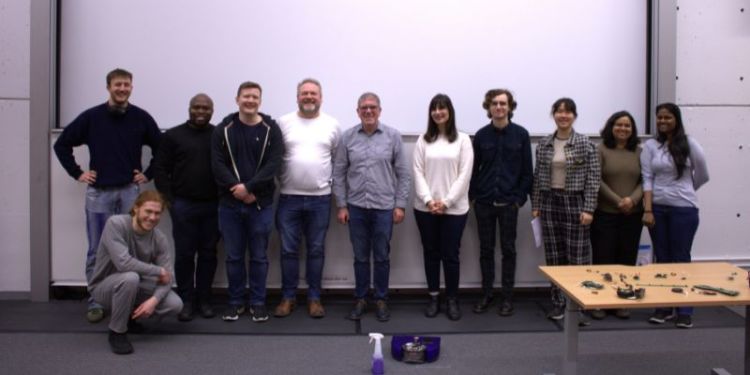 A photograph of Prof. Robert Deaves and Dr Tim Amsdon, with a group of students.