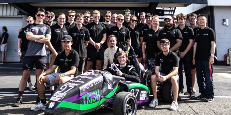 A photograph of the full Gryphon Racing team and their car at Silverstone 2022.