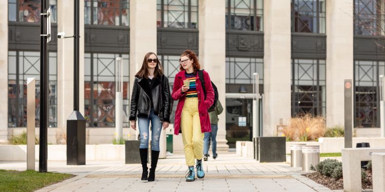 Two students walking outside the Sir William Henry Bragg building