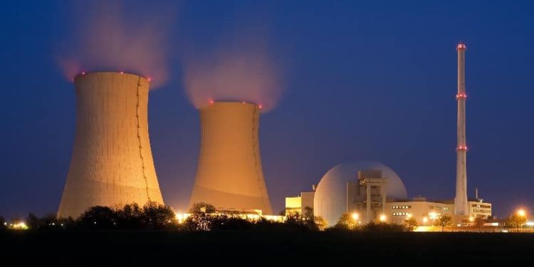 nuclear power station floodlit at night