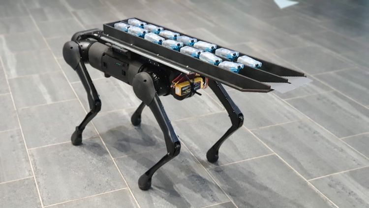 14 Miniature pipe robots laid end to end in two rows on the back of a four legged robot