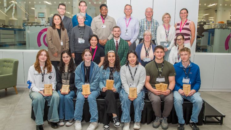 Jed Walsh sitting with student prize winners