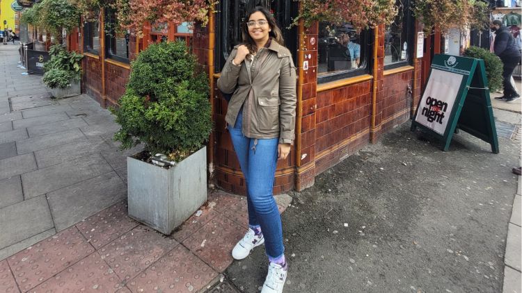 Purvi standing outside a pub on holiday