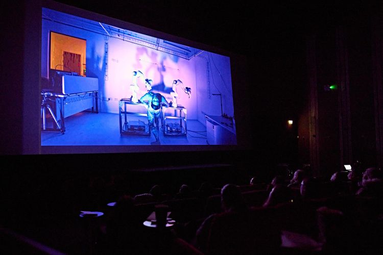 An audience watching a film on a cinema screen