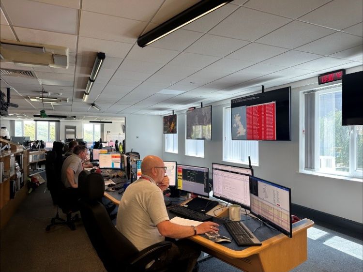 Two men sat at computer screens working in Arqiva's broadcast operations centre.