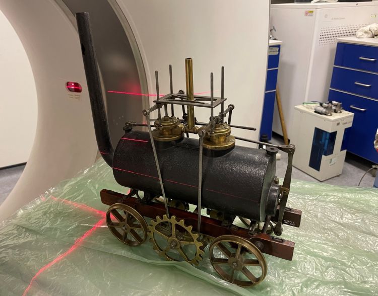 Train model on CT scanner with lasers covering the model