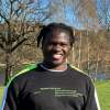 Jonathan Sisa Khabusi wearing a jumper, standing in front of a lake at roundhay park