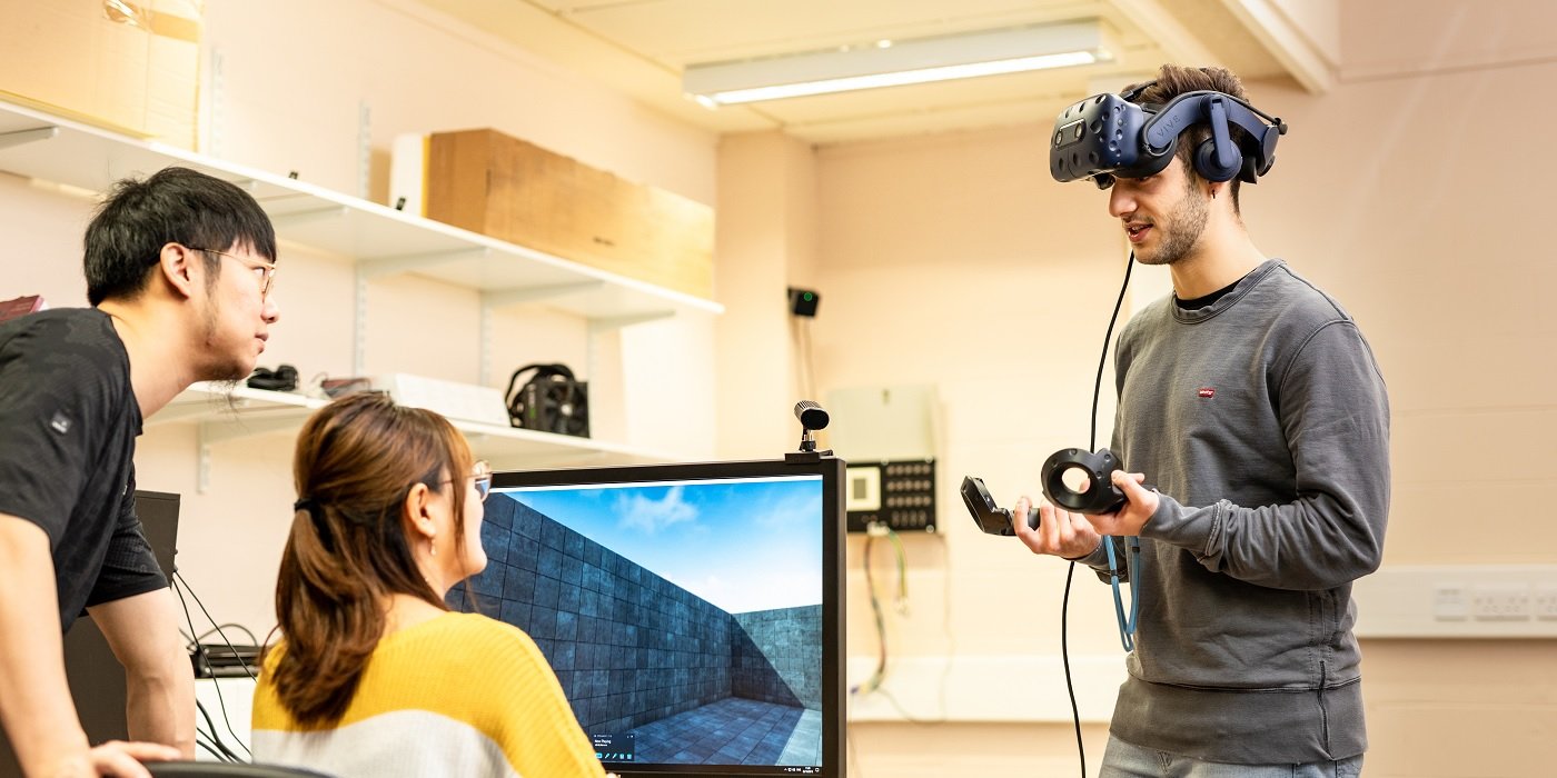 Three students using virtual reality equipment