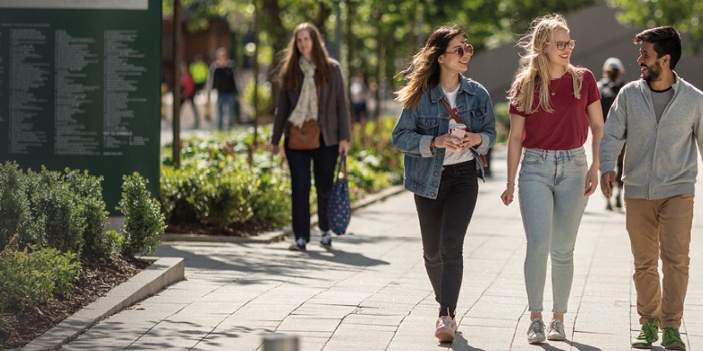 Students walking in the sun on campus
