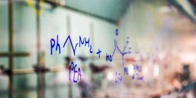 Chemical equation written on a clear board or window