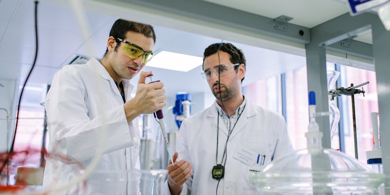 Male masters student and member of research staff working in lab
